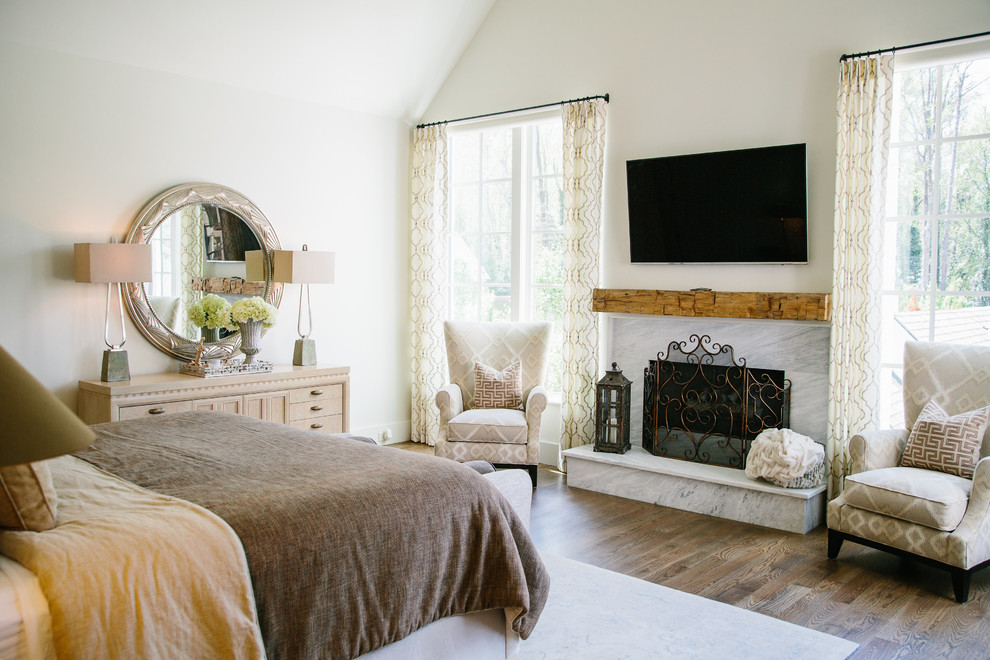 This is an example of a mid-sized transitional master bedroom in Atlanta with white walls, carpet and beige floor.