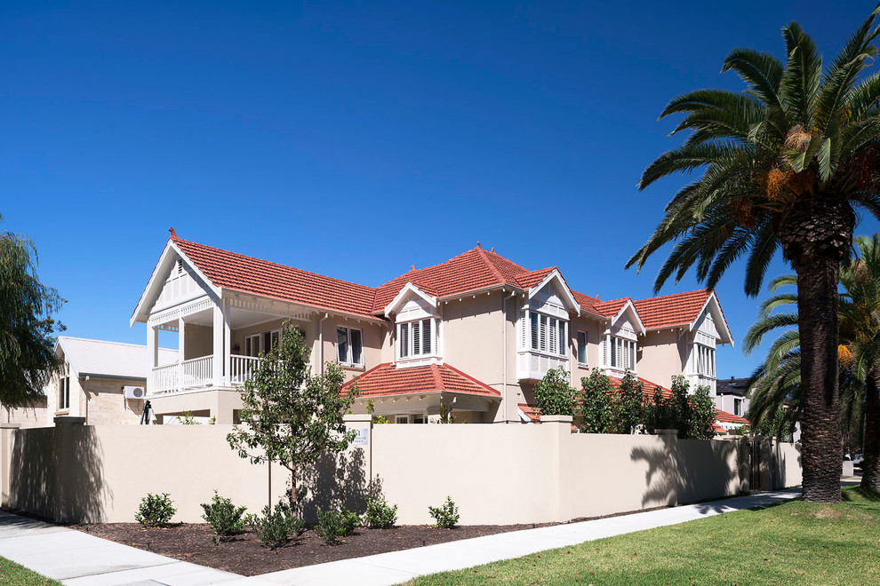 Large contemporary three-storey concrete beige house exterior in Perth with a gable roof and a tile roof.
