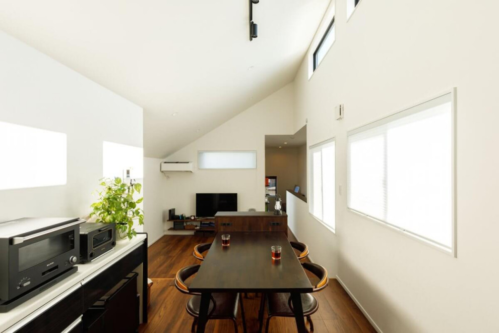 Photo of a mid-sized industrial open concept living room in Tokyo Suburbs with white walls, medium hardwood floors, no fireplace, a freestanding tv, brown floor, wallpaper and wallpaper.