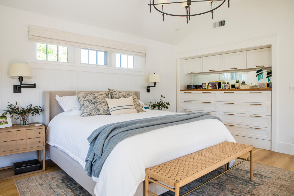 Inspiration for a large country master bedroom in San Francisco with white walls, medium hardwood flooring, brown floors and tongue and groove walls.