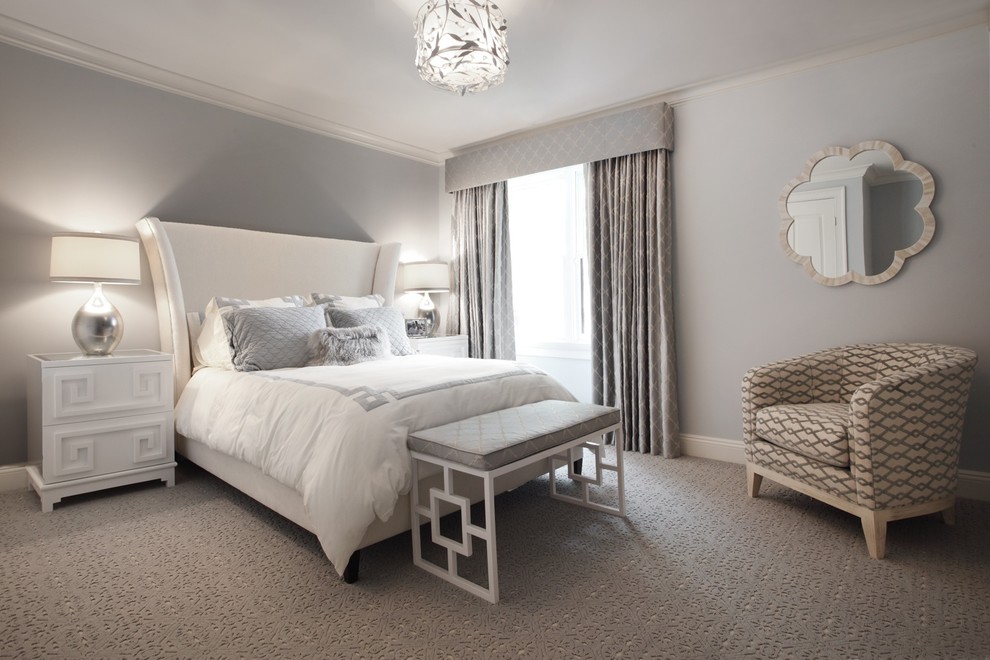 This is an example of a contemporary bedroom in New York with grey walls and carpet.
