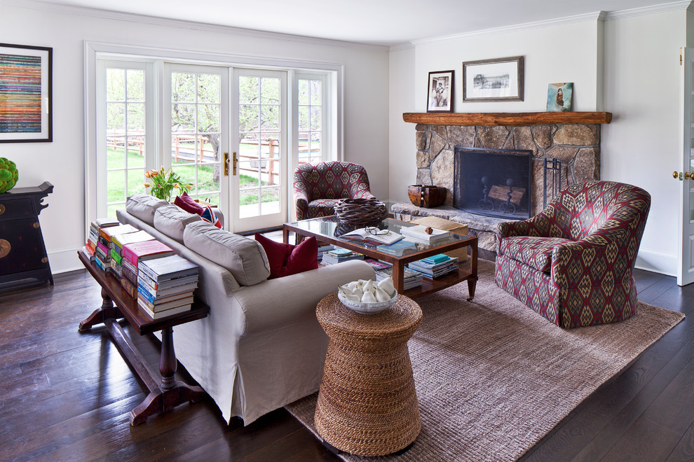 Family room - mid-sized transitional open concept dark wood floor family room idea in New York with white walls, a standard fireplace, a stone fireplace and no tv