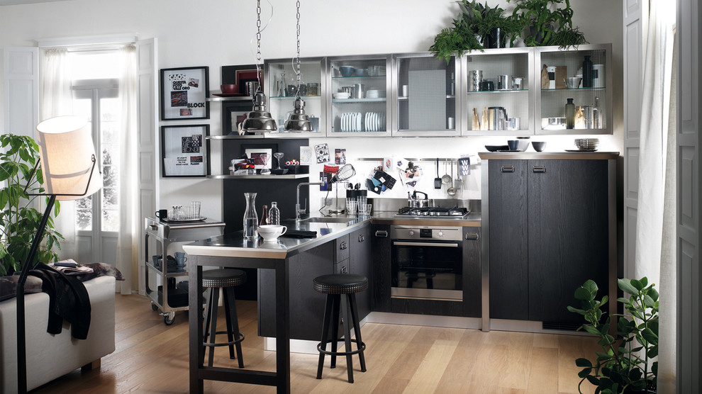 Design ideas for a small industrial single-wall eat-in kitchen in Melbourne with a single-bowl sink, raised-panel cabinets, grey cabinets, stainless steel benchtops, brown splashback, metal splashback, stainless steel appliances, light hardwood floors and multiple islands.