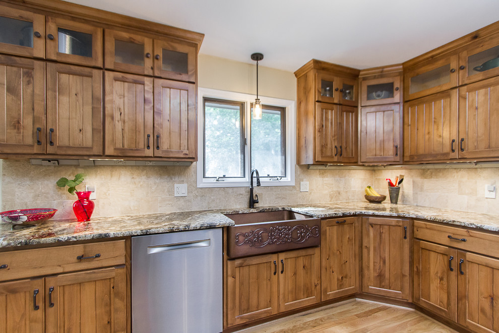 Eat-in kitchen - large rustic light wood floor eat-in kitchen idea with a farmhouse sink, light wood cabinets, granite countertops, beige backsplash, glass tile backsplash, stainless steel appliances and beige countertops