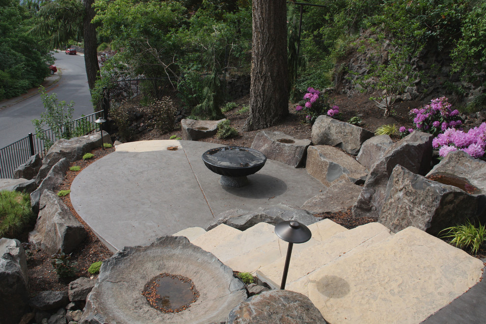 Small arts and crafts backyard patio in Seattle with a fire feature, stamped concrete and no cover.