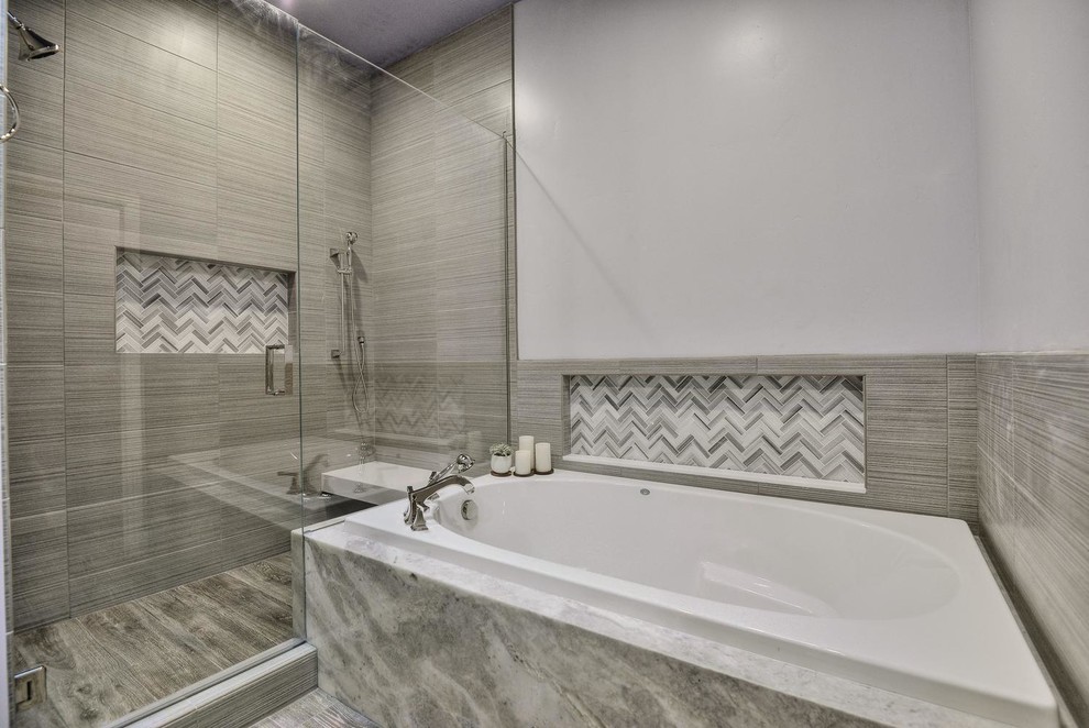 This is an example of an expansive contemporary master bathroom in San Francisco with a drop-in tub, an open shower, a one-piece toilet, gray tile, purple walls, linoleum floors, grey floor and a hinged shower door.