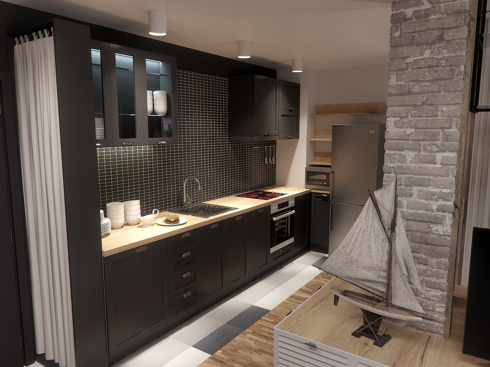 Inspiration for a mid-sized industrial l-shaped open plan kitchen in London with a drop-in sink, beaded inset cabinets, black cabinets, wood benchtops, black splashback, ceramic splashback, stainless steel appliances, terra-cotta floors and no island.