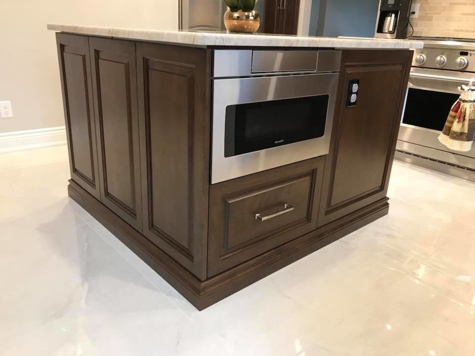 Mid-sized transitional u-shaped marble floor and beige floor eat-in kitchen photo with an undermount sink, raised-panel cabinets, beige cabinets, quartzite countertops, beige backsplash, marble backsplash, stainless steel appliances and an island