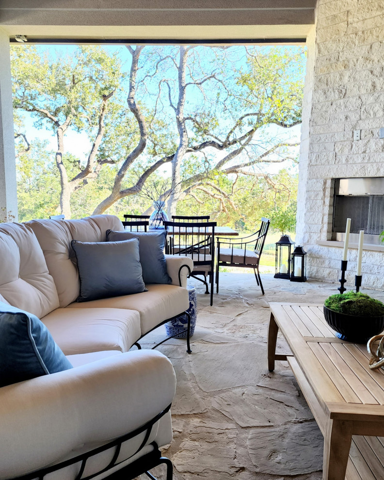 Design ideas for a large classic back veranda in Austin with an outdoor kitchen and natural stone paving.