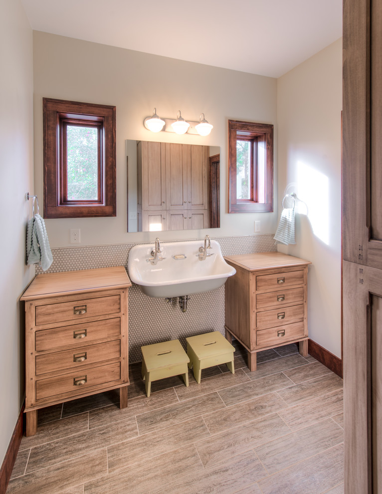 Design ideas for a transitional kids bathroom in Denver with a trough sink, beige tile and light wood cabinets.