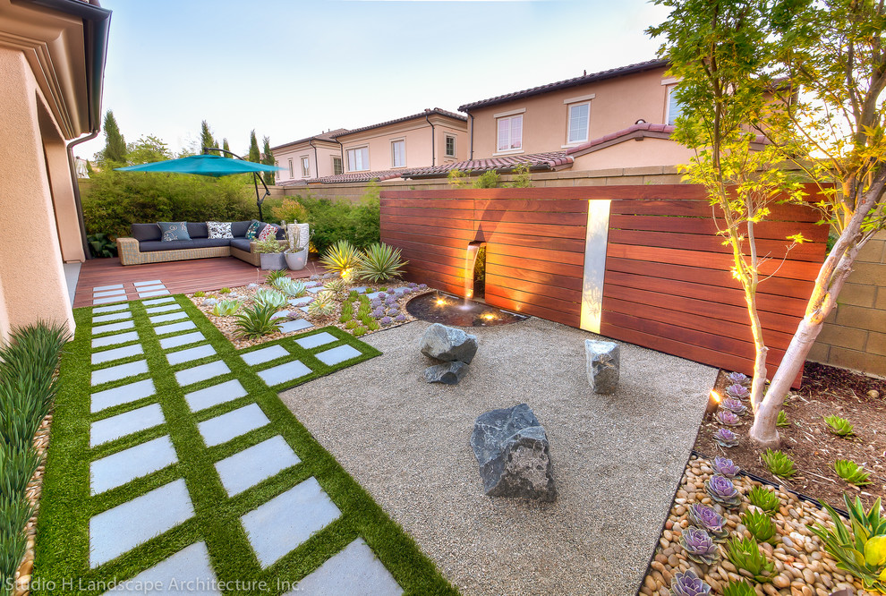 This is an example of a small contemporary side yard partial sun xeriscape in Orange County with a garden path and gravel.