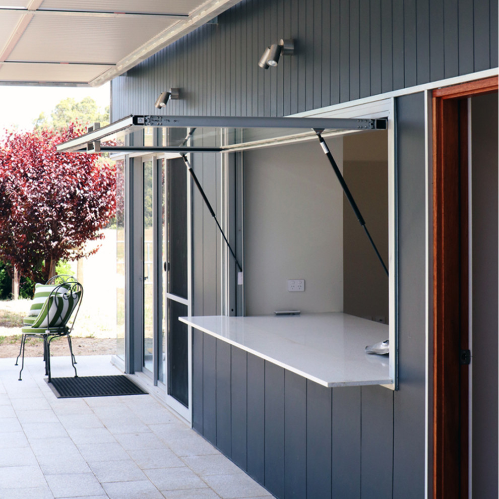 Photo of a contemporary grey exterior in Other with concrete fiberboard siding and a grey roof.