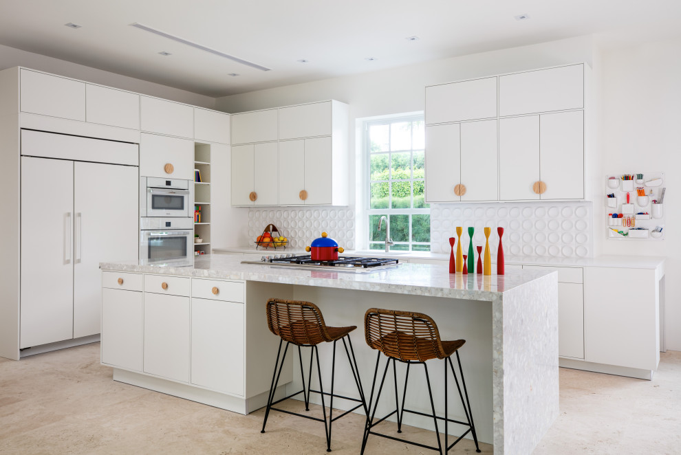 Contemporary l-shaped kitchen in Miami with flat-panel cabinets, white cabinets, marble benchtops, white splashback, porcelain splashback, white appliances, ceramic floors, with island, beige floor and white benchtop.