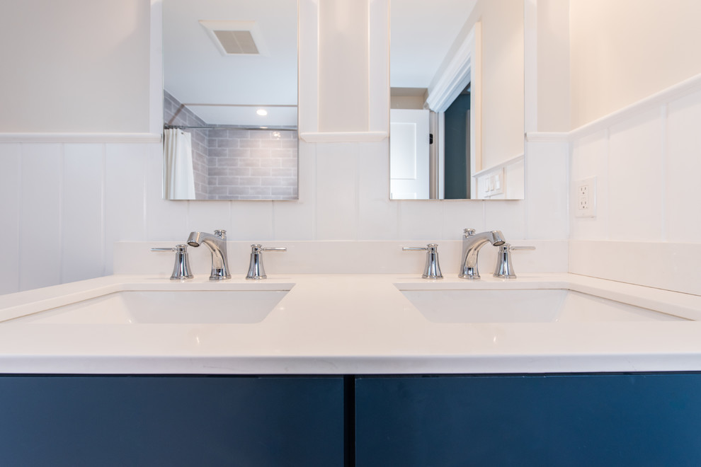 Design ideas for a mid-sized contemporary kids bathroom in DC Metro with recessed-panel cabinets, blue cabinets, a shower/bathtub combo, a two-piece toilet, orange walls, an undermount sink, engineered quartz benchtops and a shower curtain.