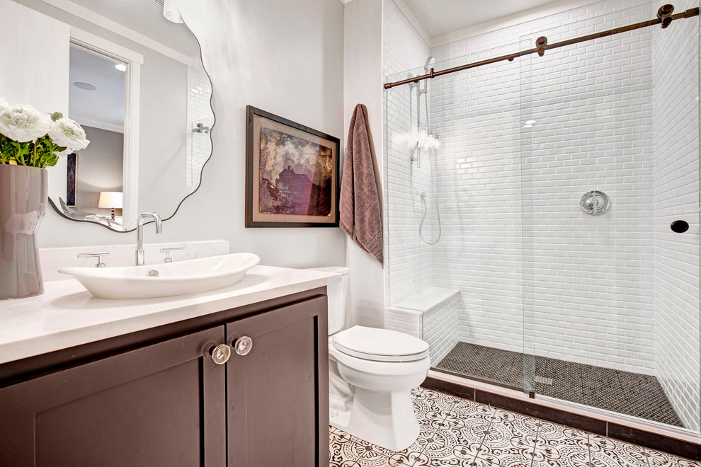 This is an example of a country 3/4 bathroom in Seattle with brown cabinets, a freestanding tub, white tile, subway tile, porcelain floors, a vessel sink, quartzite benchtops and a sliding shower screen.