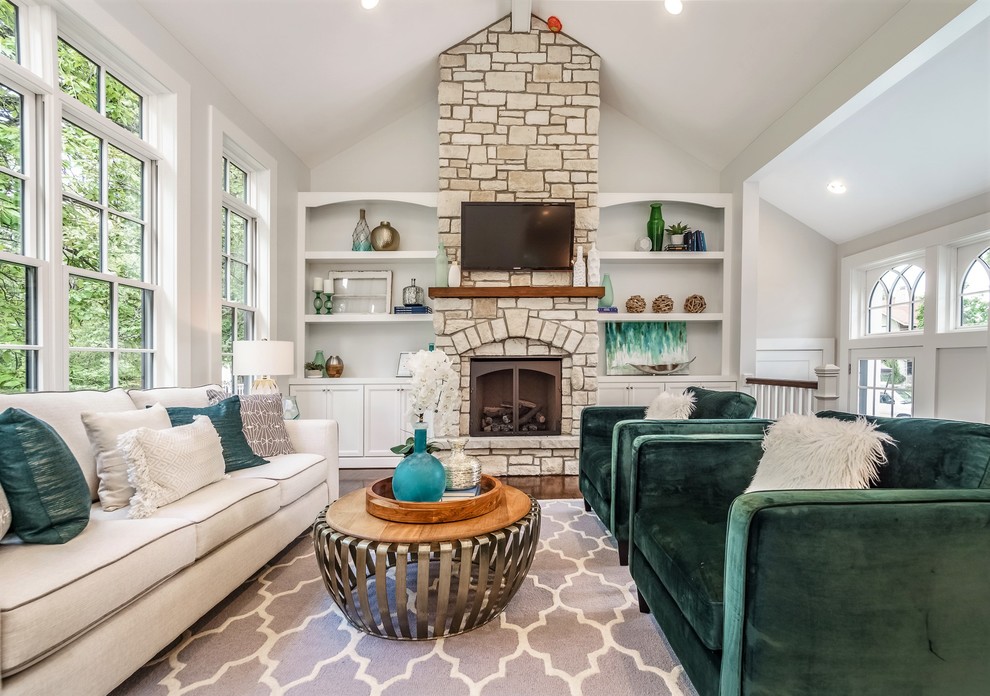 Mid-sized arts and crafts formal enclosed living room in St Louis with grey walls, dark hardwood floors, a standard fireplace, a stone fireplace surround, a wall-mounted tv and brown floor.