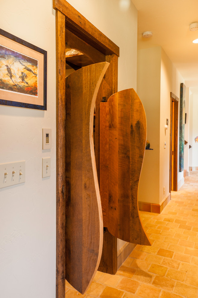Inspiration for a mid-sized rustic brown floor and medium tone wood floor hallway remodel in Seattle with beige walls
