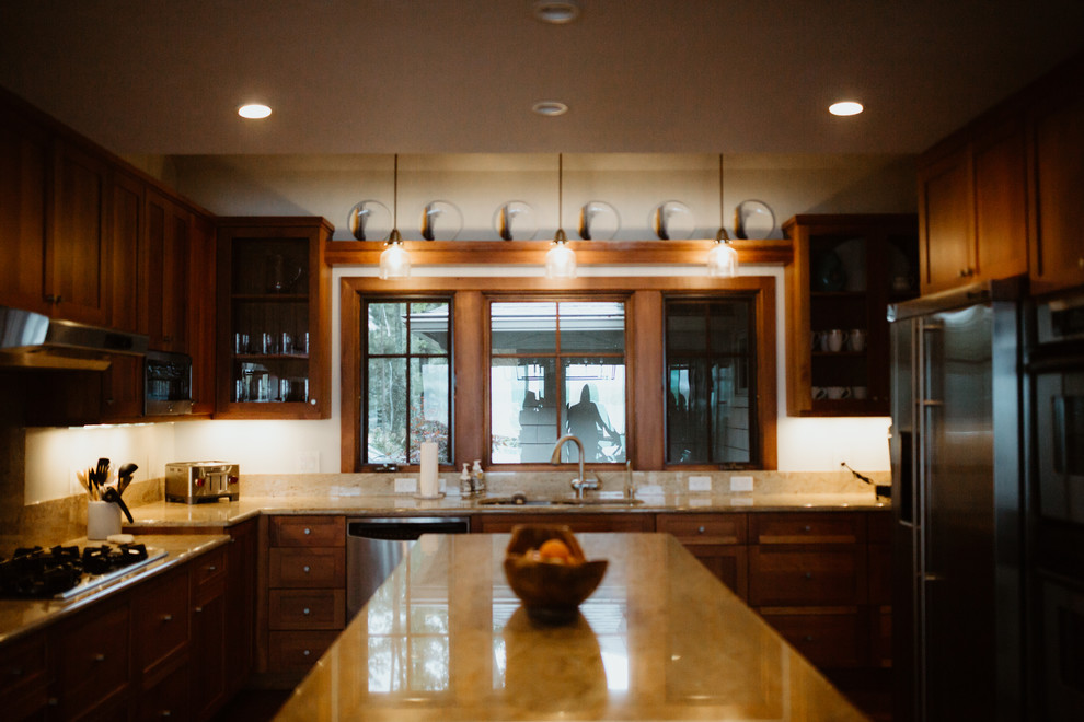 Large minimalist enclosed kitchen photo with dark wood cabinets, stainless steel appliances, an island and beige countertops