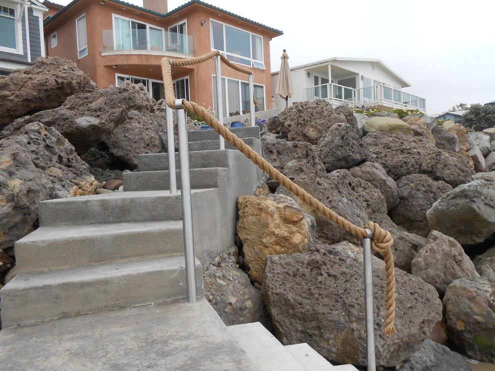 This is an example of a mid-sized beach style concrete curved staircase in Los Angeles with concrete risers.