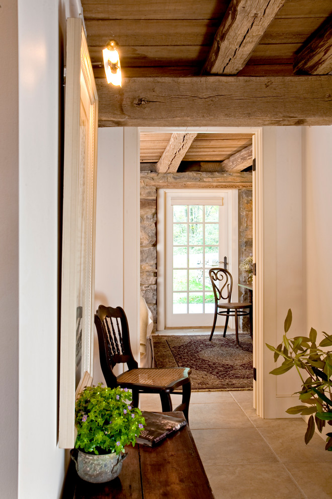 Photo of a large country hallway in Philadelphia with white walls and limestone floors.