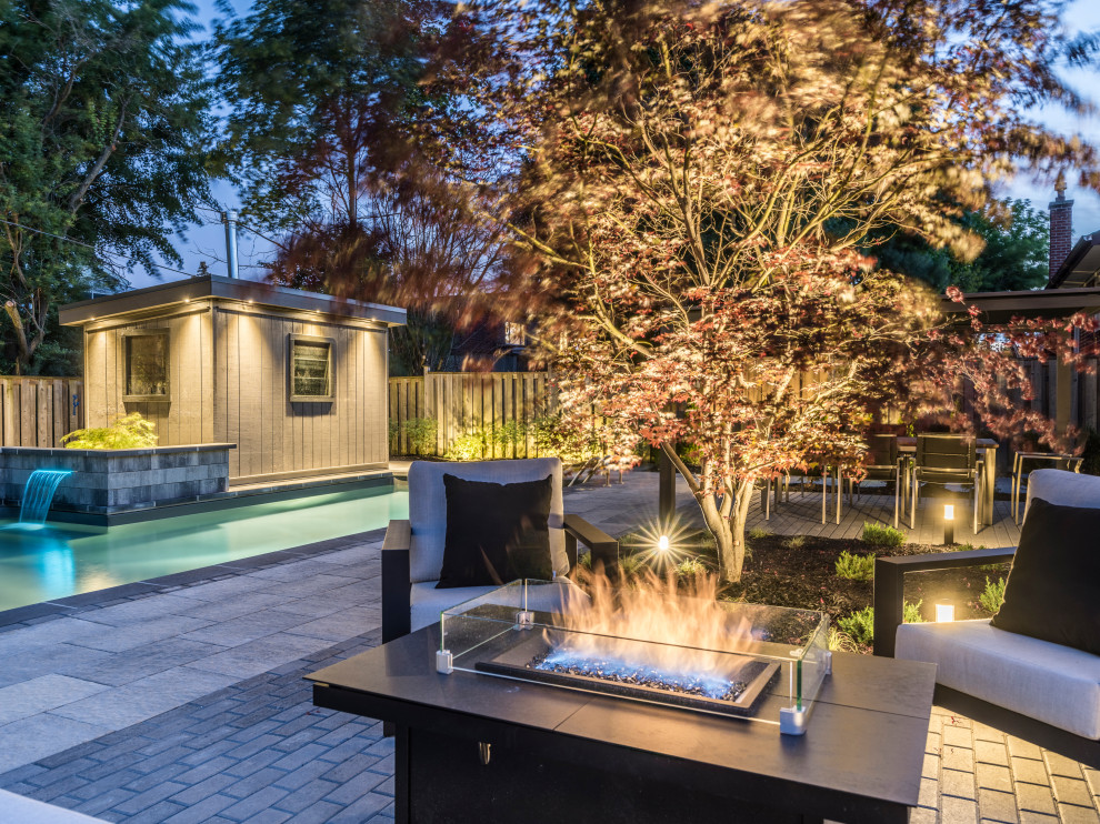 Pool fountain - mid-sized transitional backyard concrete paver and l-shaped lap pool fountain idea in Toronto