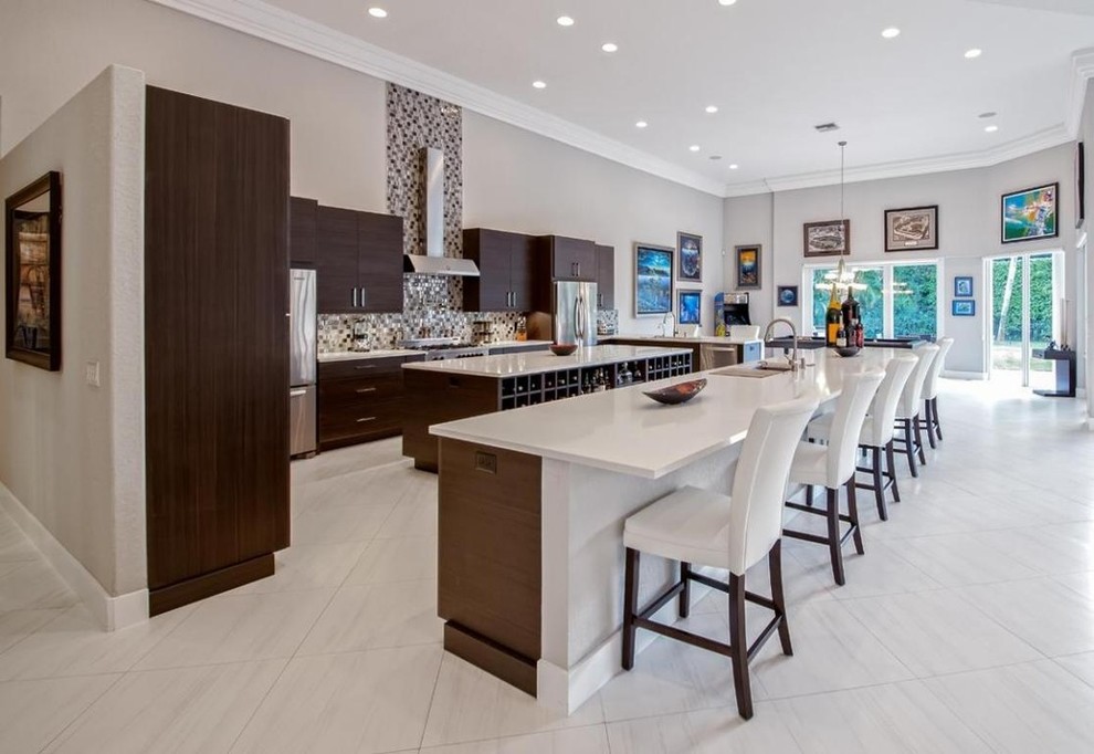 Photo of an expansive contemporary u-shaped eat-in kitchen in Miami with flat-panel cabinets, dark wood cabinets, quartz benchtops, multi-coloured splashback, multiple islands, an undermount sink and stainless steel appliances.