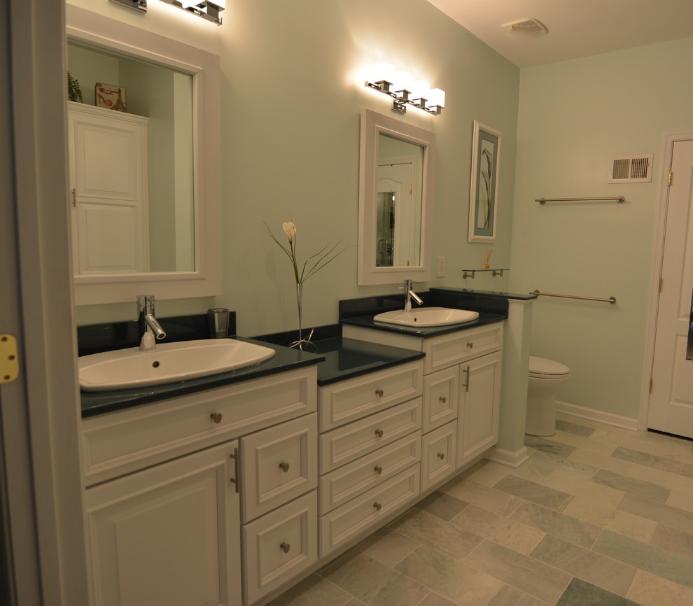 Large transitional master bathroom in Baltimore with recessed-panel cabinets, white cabinets, a one-piece toilet, blue walls, porcelain floors and a drop-in sink.