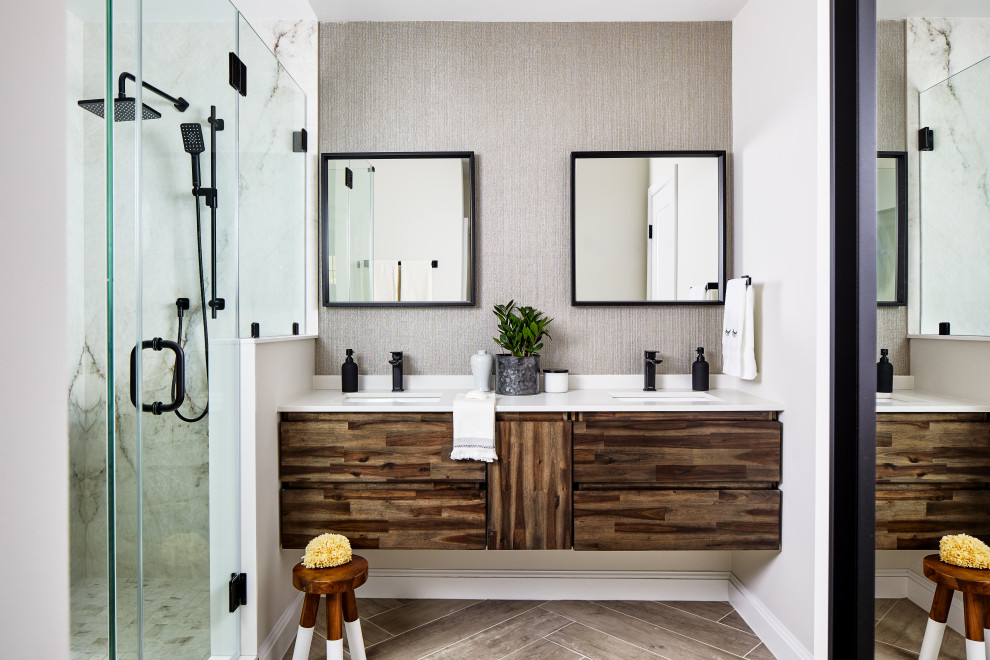 Mid-sized contemporary master bathroom in DC Metro with flat-panel cabinets, dark wood cabinets, an alcove shower, gray tile, limestone, grey walls, porcelain floors, an undermount sink, engineered quartz benchtops, grey floor, a hinged shower door, white benchtops, a double vanity and a floating vanity.
