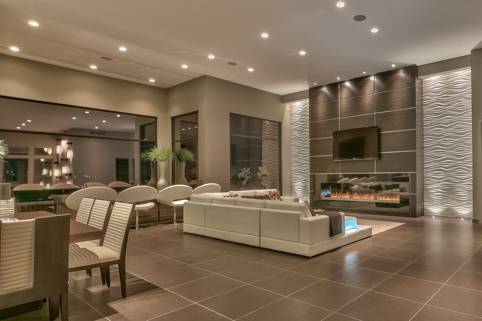 Inspiration for an expansive contemporary open concept living room in Omaha with grey walls, a ribbon fireplace, a wall-mounted tv, a metal fireplace surround, brown floor and a home bar.