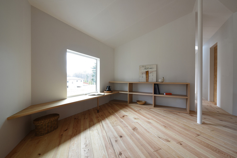 Imagen de sala de estar con biblioteca abierta y blanca ecléctica pequeña con paredes blancas, suelo de madera clara, estufa de leña y televisor colgado en la pared