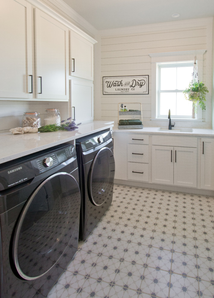 Design ideas for a country l-shaped laundry room with an undermount sink, recessed-panel cabinets, white cabinets, quartz benchtops, porcelain floors, a side-by-side washer and dryer, multi-coloured floor, white benchtop and planked wall panelling.