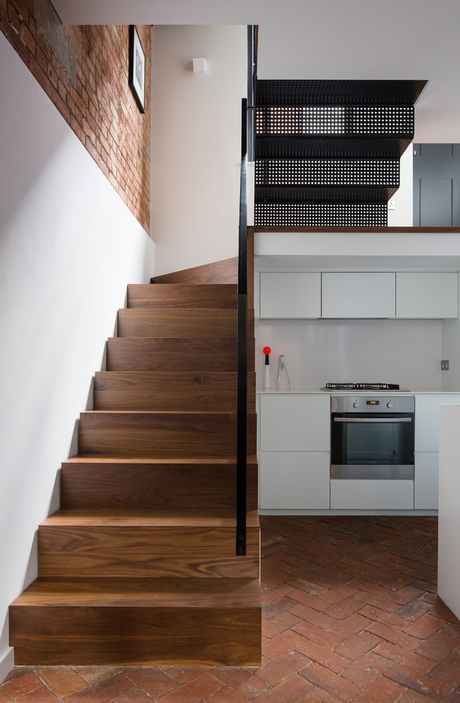 Small industrial wood floating staircase in London with wood risers.