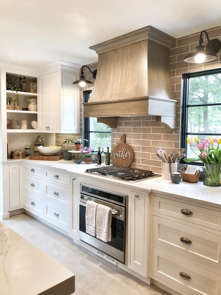 Design ideas for a large country galley kitchen pantry in Other with a drop-in sink, shaker cabinets, white cabinets, quartz benchtops, beige splashback, ceramic splashback, stainless steel appliances, limestone floors, with island, grey floor and white benchtop.