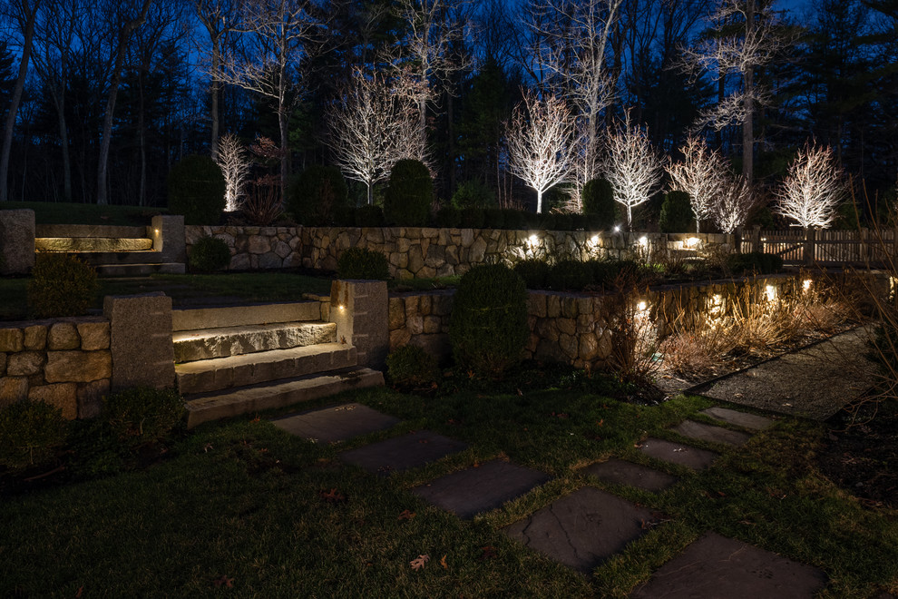 Photo of a large traditional backyard full sun garden in Boston with a retaining wall.