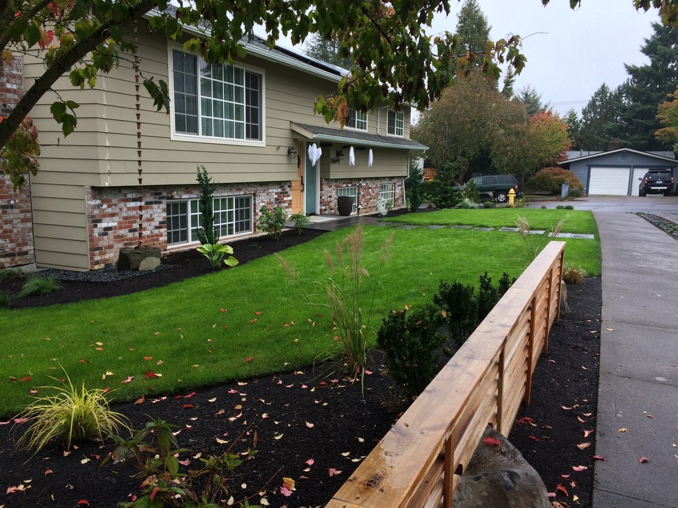 This is an example of a mid-sized contemporary front yard full sun garden in Portland.