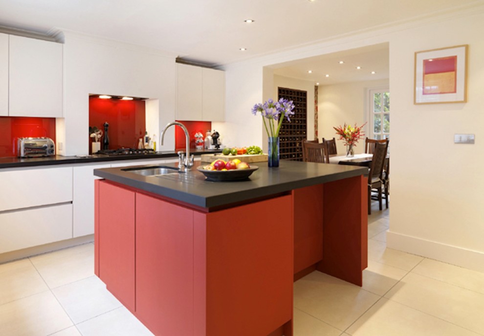 Inspiration for a large contemporary open plan kitchen in London with flat-panel cabinets, red cabinets, solid surface benchtops, stainless steel appliances and with island.