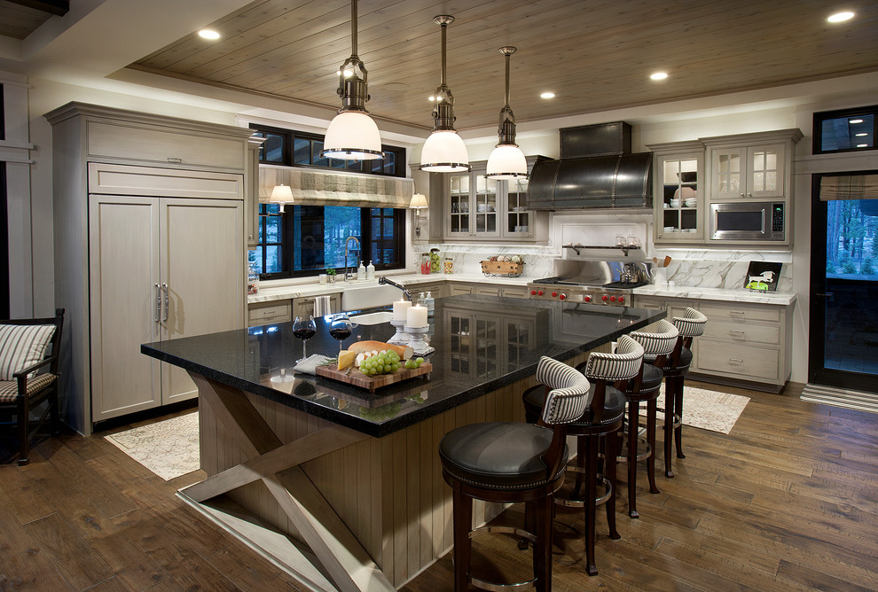Design ideas for a country l-shaped kitchen in Sacramento with a farmhouse sink, shaker cabinets, grey cabinets, white splashback, panelled appliances and dark hardwood floors.