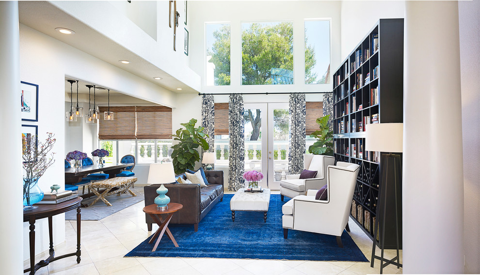 Contemporary open concept living room in Las Vegas with a library and white walls.