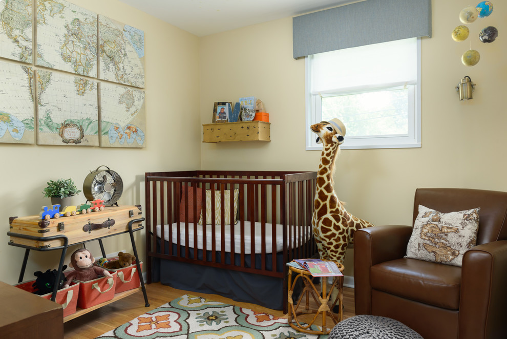 Inspiration for a small transitional nursery for boys in DC Metro with beige walls and light hardwood floors.