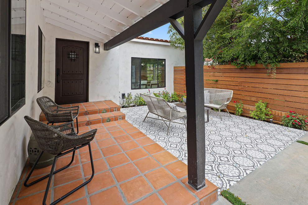 Mid-sized transitional backyard tile patio photo in Los Angeles with a roof extension