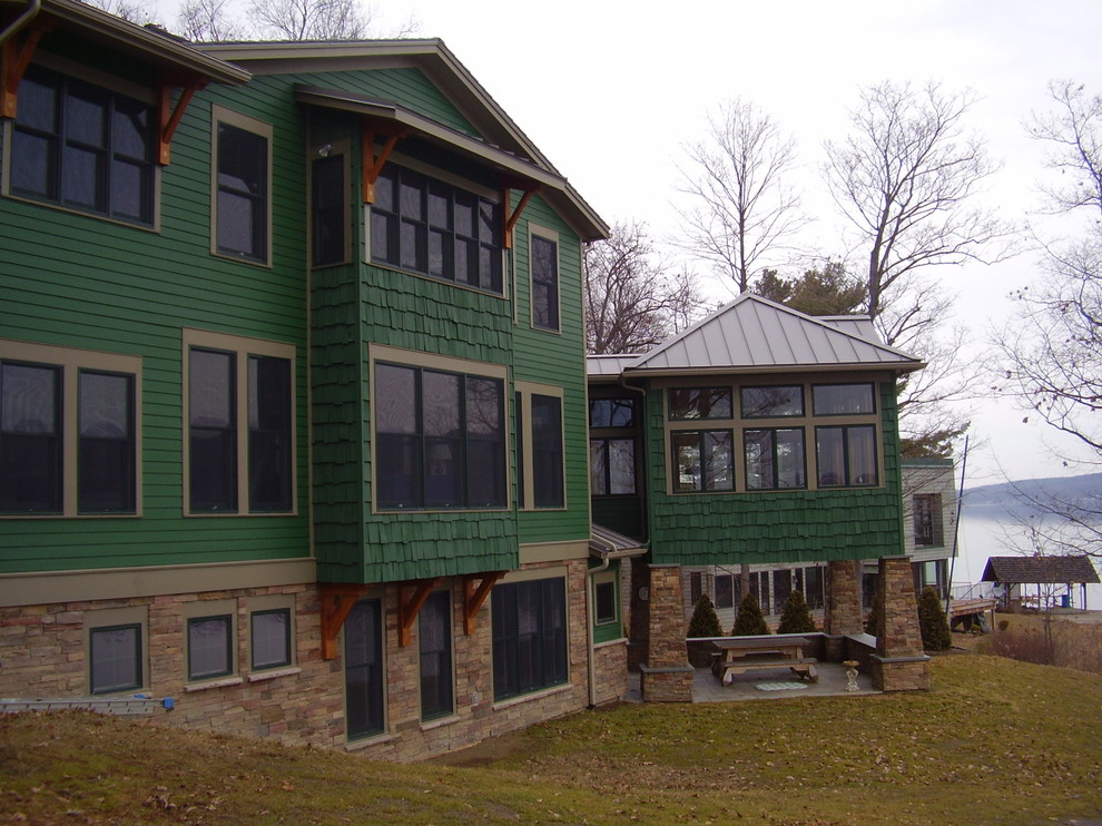 Large arts and crafts three-storey green exterior in New York.