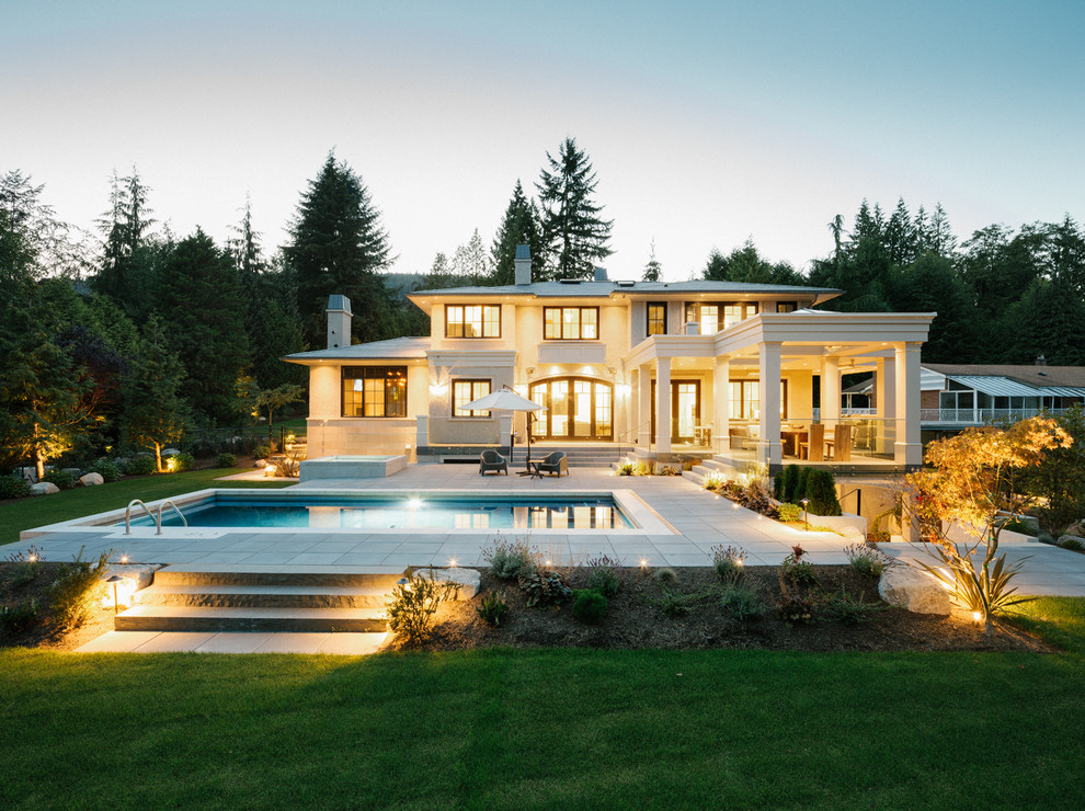 Inspiration for a large transitional two-storey stucco beige exterior in Vancouver.