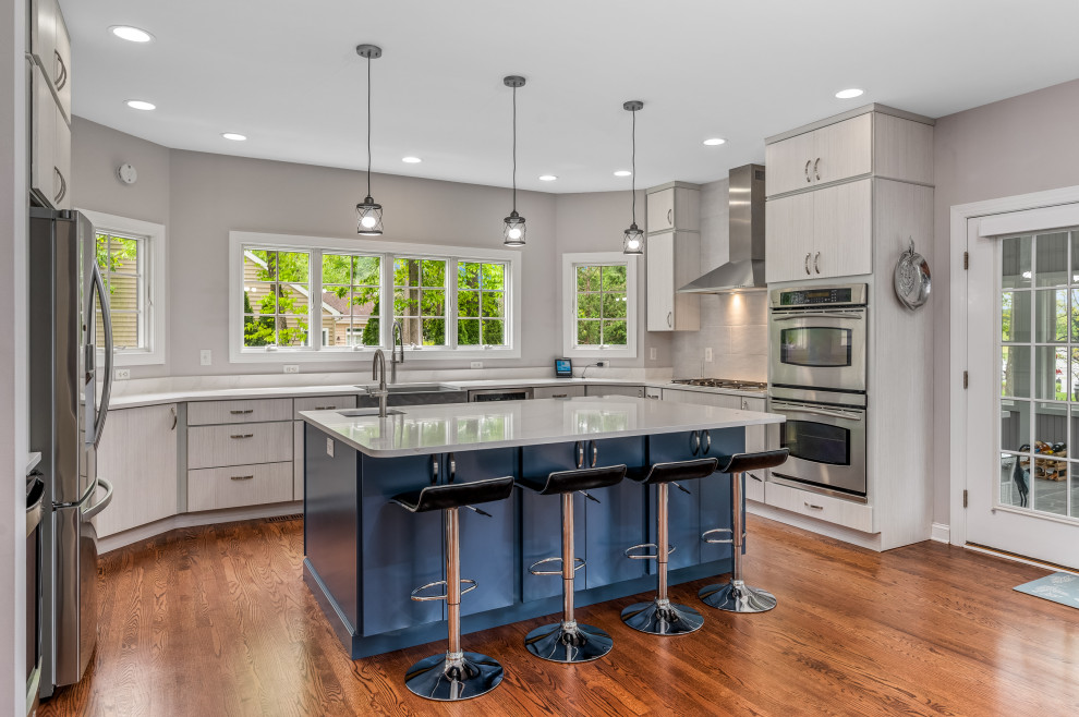 Large minimalist u-shaped kitchen photo in DC Metro with a farmhouse sink, flat-panel cabinets, quartz countertops, stone tile backsplash, stainless steel appliances, an island and white countertops