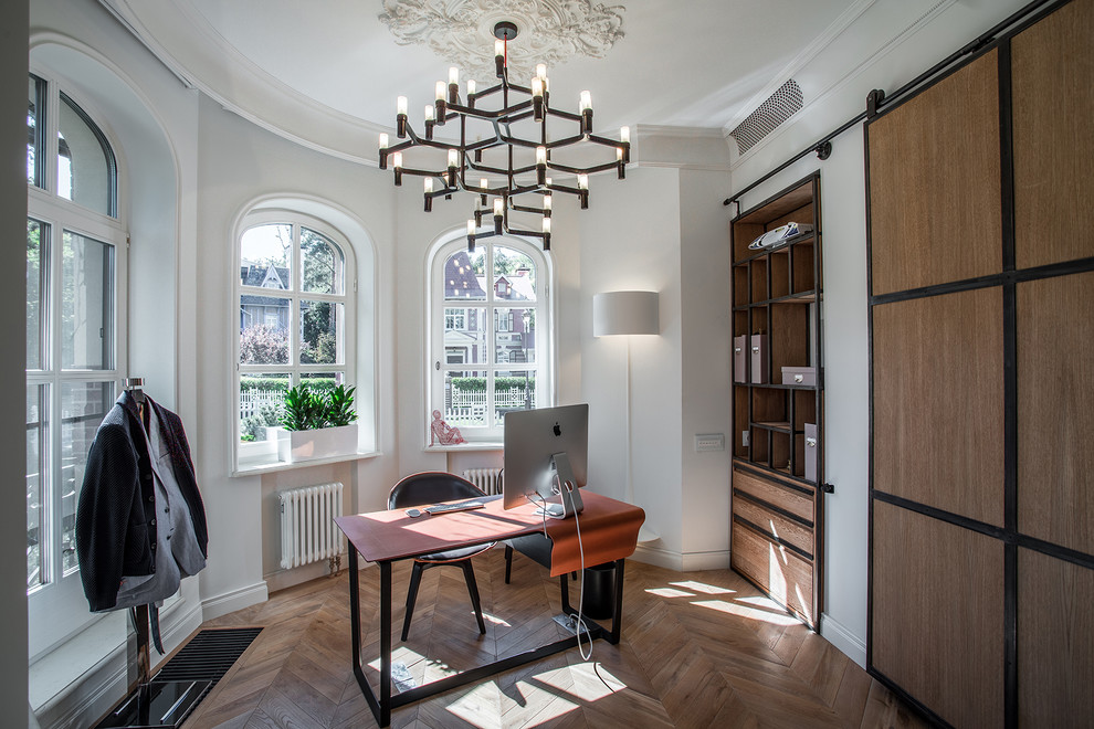 Photo of a contemporary home office in Moscow with white walls, medium hardwood floors and a freestanding desk.