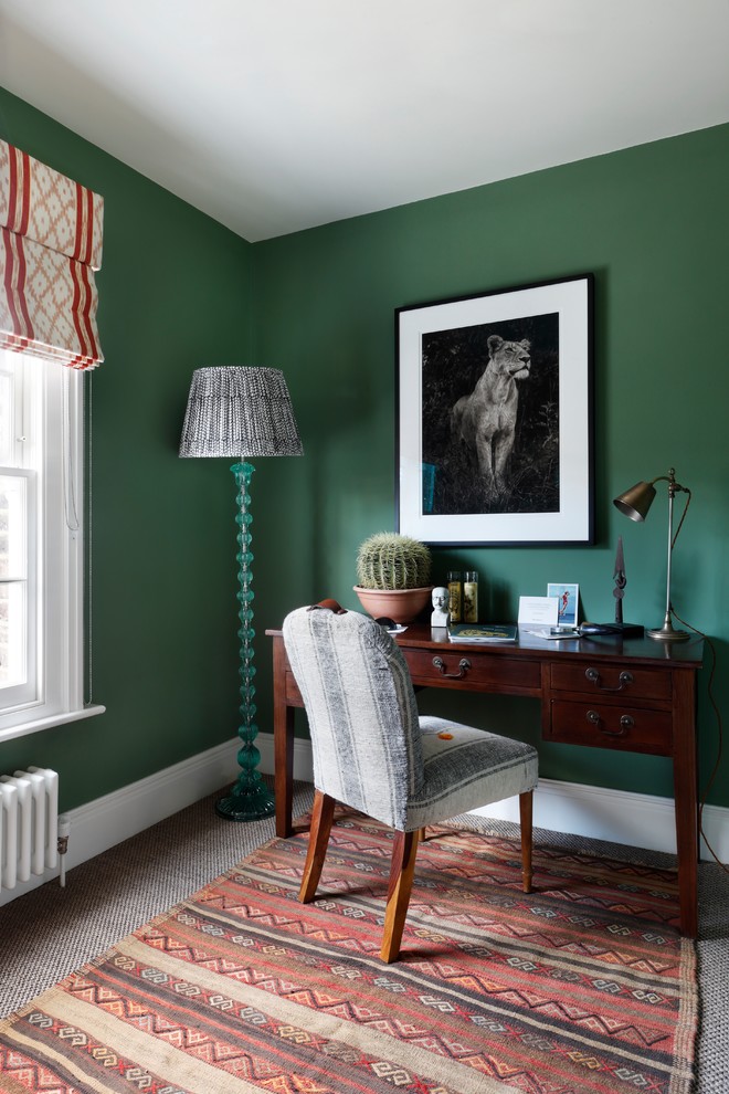 Design ideas for an eclectic study room in London with green walls, concrete floors, a freestanding desk and grey floor.