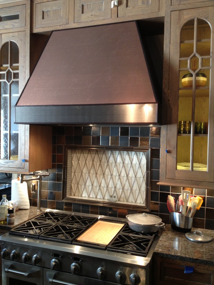 Kitchen - transitional u-shaped kitchen idea in Oklahoma City with glass-front cabinets, distressed cabinets and granite countertops