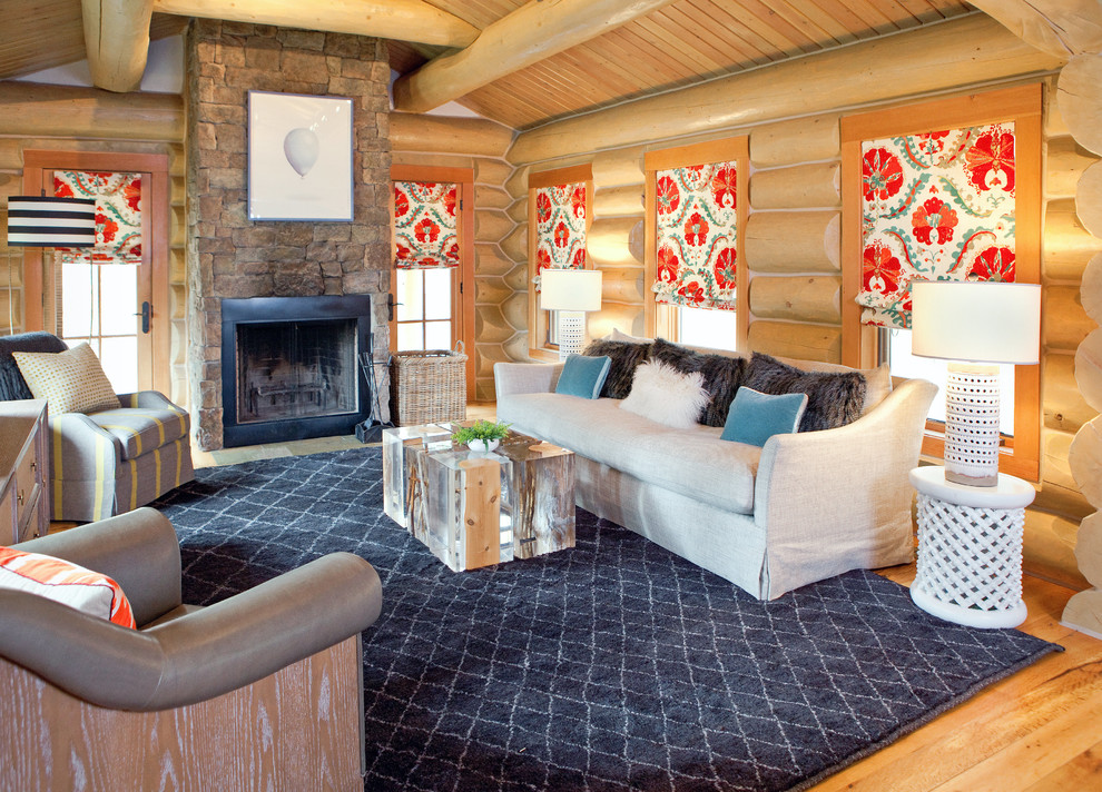 This is an example of a country living room in Other with a standard fireplace and a stone fireplace surround.