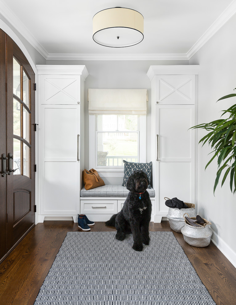 Photo of a beach style mudroom in Chicago with grey walls, dark hardwood floors, a double front door, a dark wood front door and brown floor.