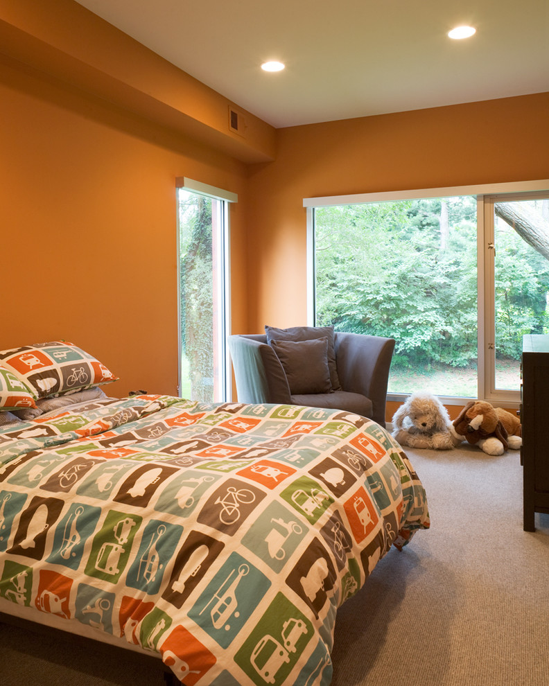 This is an example of a contemporary kids' room for boys in Kansas City with orange walls.