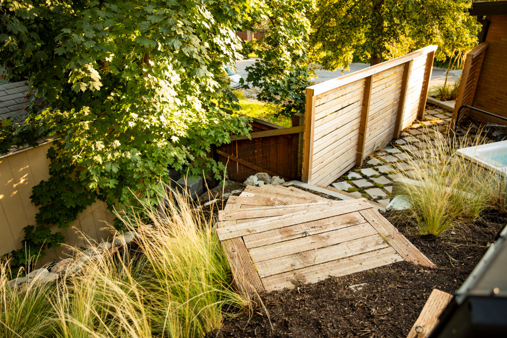 Photo of a medium sized contemporary back garden steps in Salt Lake City with concrete paving and a wood fence.